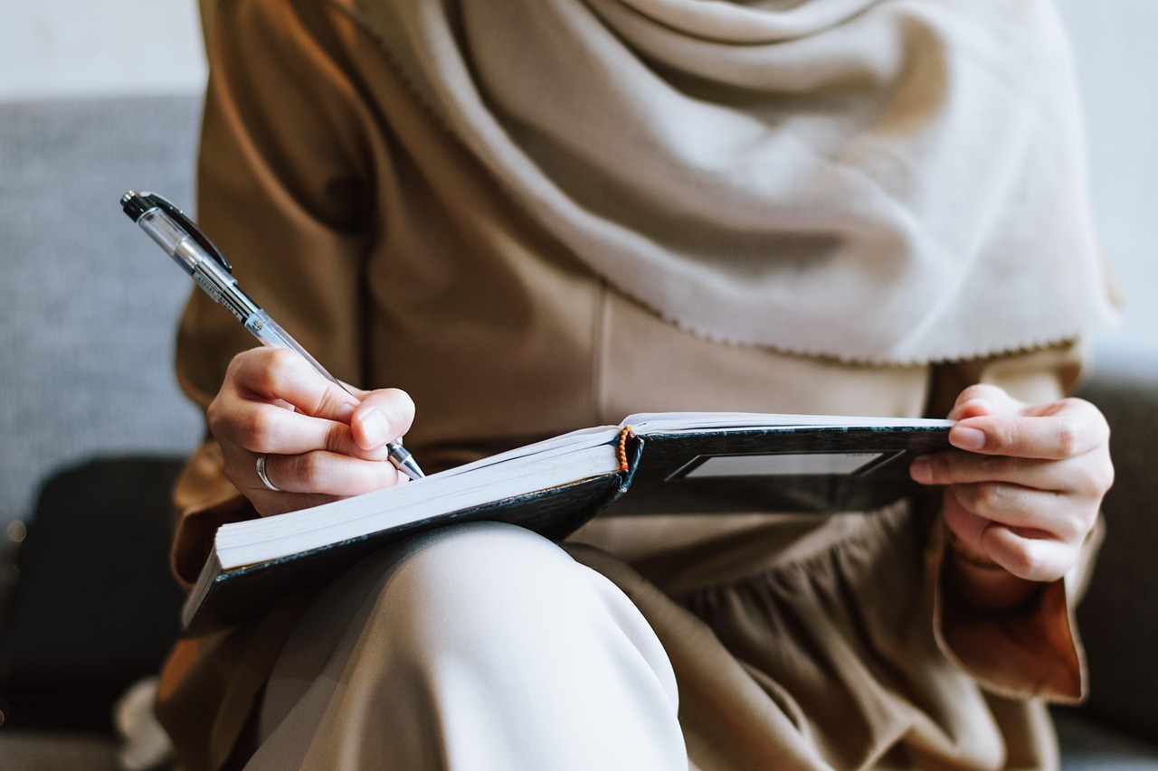 Muslim, woman, writing — Empowering Individuals: No Credit Check Loans for Canadians with Disabilities